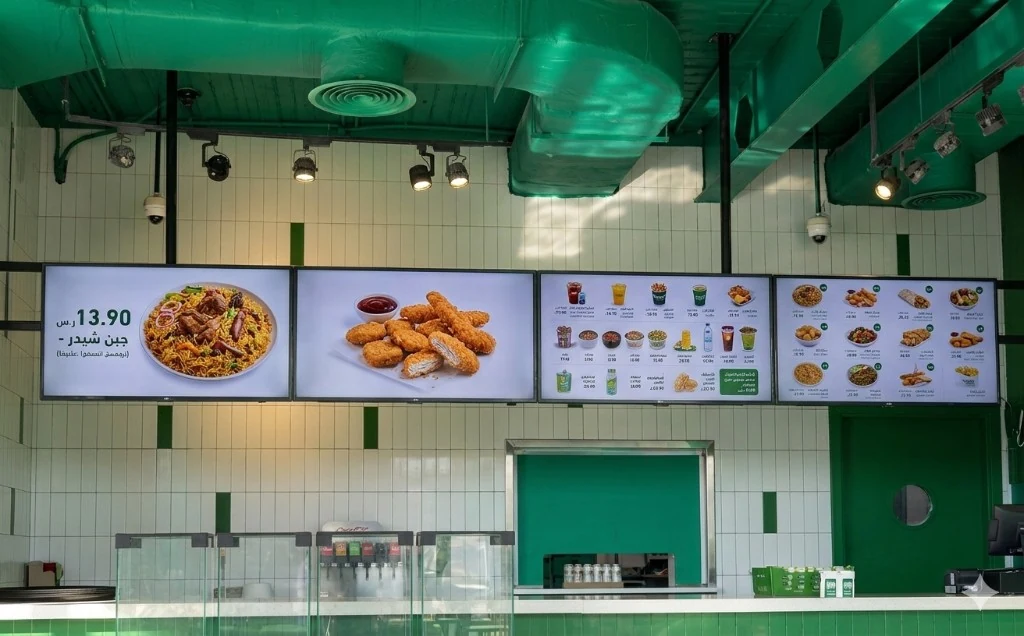 Genix signage workspace showing playlists, layouts, and screen previews